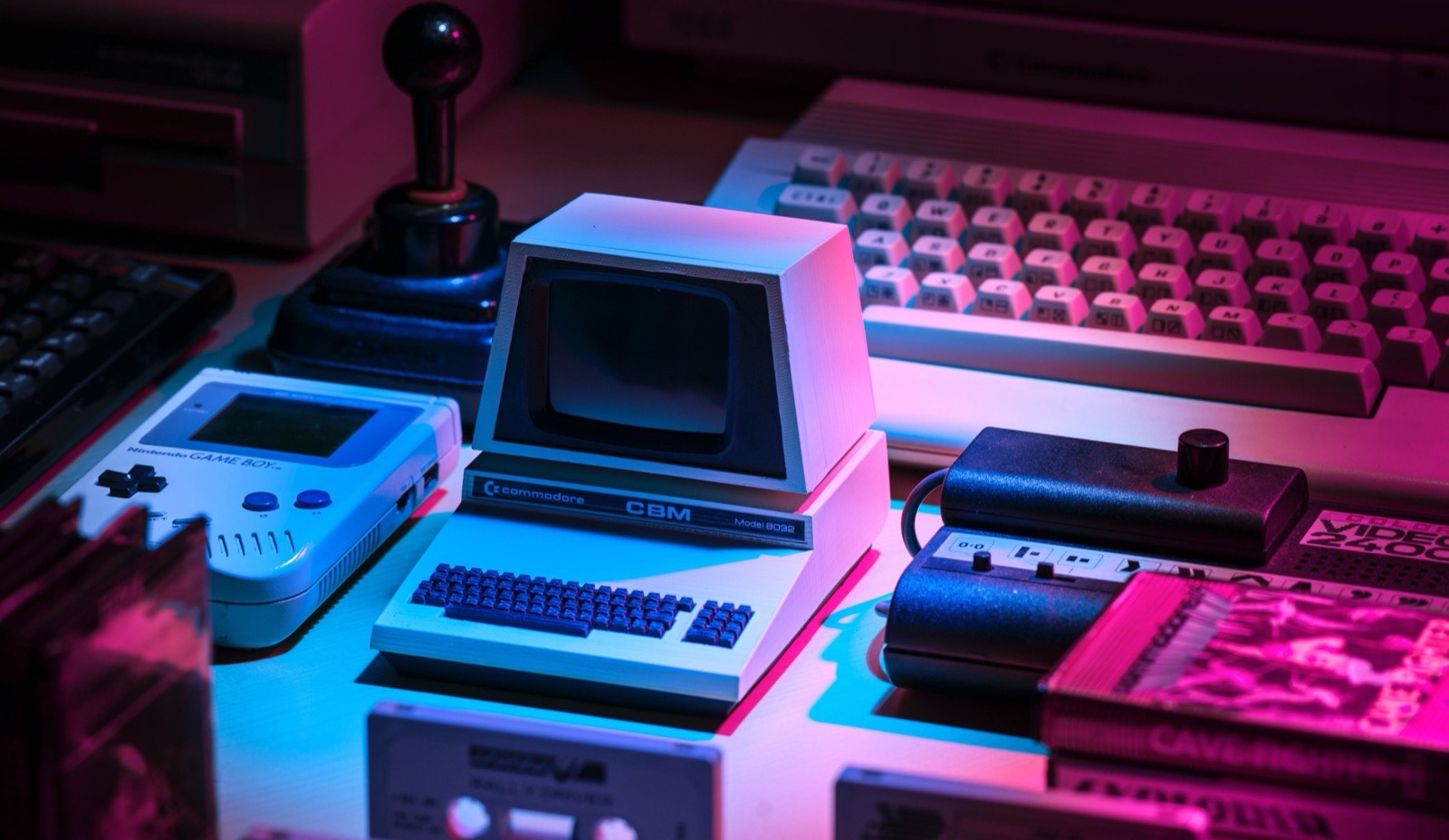 Vintage gray game console and assorted computer equipment